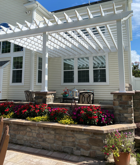 Stunning elevated outdoor space in Lewes, DE, showcasing a modern white pergolized roof for a stylish touch.